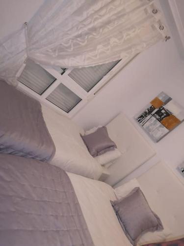 a bedroom with a large bed with two pillows at Casa JC in Orihuela Costa