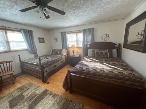 a bedroom with two beds and a ceiling fan at Smiths mother-in-law suite! Pet friendly! in Valley Head