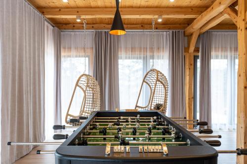 a pool table in a room with windows at REZYDENCJA SPISZ dom 12 osób, podgrzewany basen, sauna, jacuzzi- velo Czorsztyn, Niedzica in Niedzica Zamek