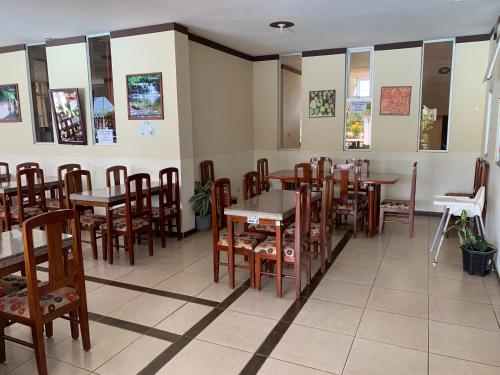 a dining room with wooden tables and chairs at Hotel Palmar del Río Premium in Archidona