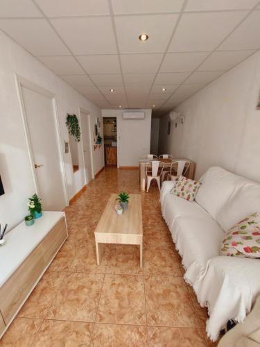 ロスピタレート・デ・リンファントにあるApartamento Sant Rocのリビングルーム(白いソファ2台、テーブル付)