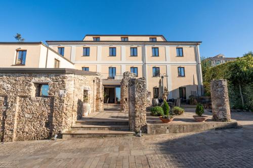 a large building with stone pillars in front of it at Hotel Ristorante Vecchia Vibo in Vibo Valentia