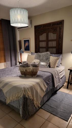 a bedroom with a bed with two baskets on it at Casa Bonita Fajardo in Fajardo