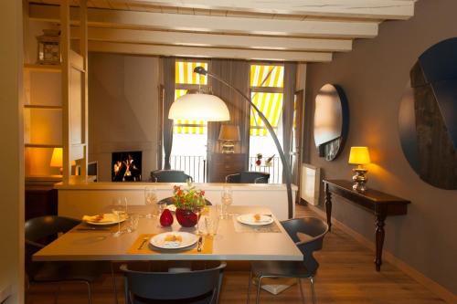 a dining room with a table and chairs at Nest on The Lake in Marone