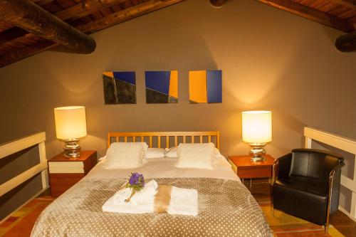 a bedroom with a bed with a chair and two lamps at Nest on The Lake in Marone
