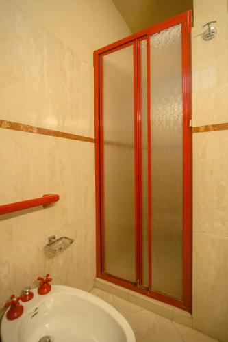 a bathroom with a shower and a white sink at Nest on The Lake in Marone