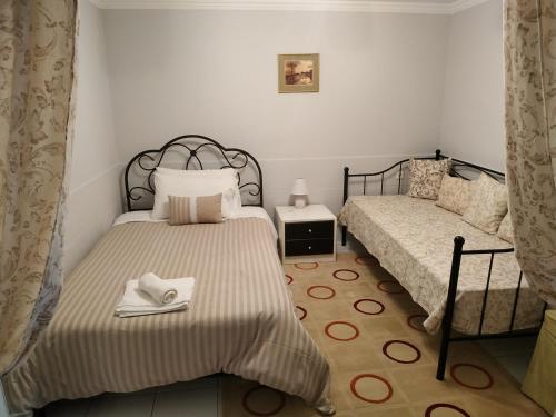 a bedroom with two beds with towels on them at Linda's house in Agria