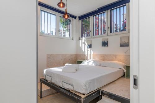 sypialnia z łóżkiem w pokoju z oknami w obiekcie [Sweet apartment] - Grazioli 2 w Mediolanie