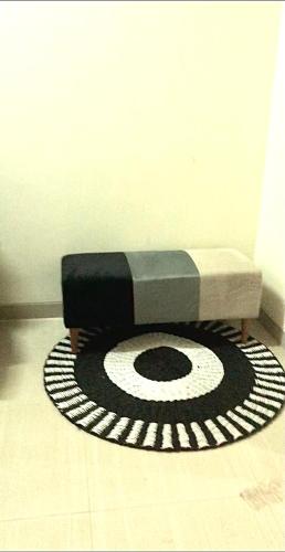 a dog bed sitting on top of a rug on a floor at Sacca Studio Home in Benoa in Ujung