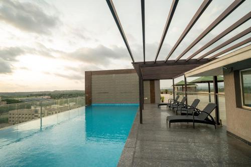 a swimming pool on the roof of a building at Ananth The Grand in Hubli