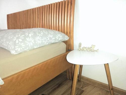 a bed and a side table in a room at Apartmány ZELENÝ DOM in Podhájska