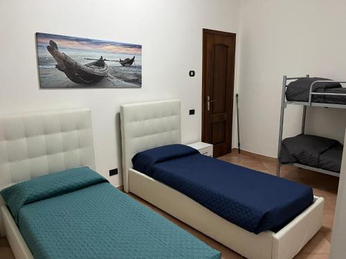 a bedroom with two beds and two bunk beds at LA CASA DI FLO in Anzio