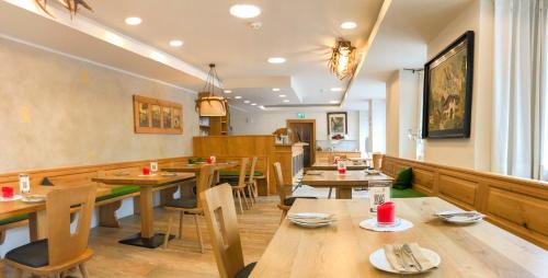 a dining room with wooden tables and chairs at Hotel Goldener Löwe in Kufstein