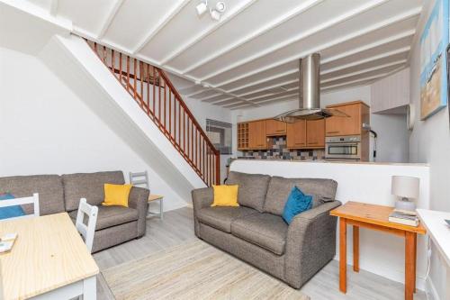 a living room with two couches and a table at 5 Stable Cottages , Hartington Road, Cromer.North Norfolk. NR27 0EJ in Cromer