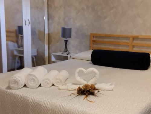 a bed with a bunch of towels and a spider on it at Casa vacanza Giovanni Salvatori in Orvieto Scalo