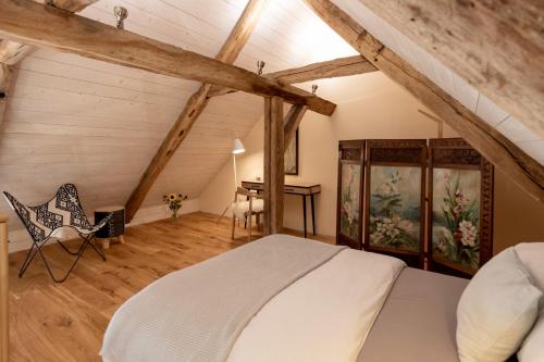 a bedroom with a bed and a desk in a attic at Gut Junkernhof in Calden