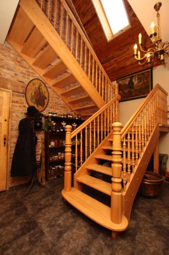 a wooden staircase in a room with a vaulted ceiling at DOM GOŚCINNY PTASZARNIA - NATURA-Free PARKING in Świnoujście