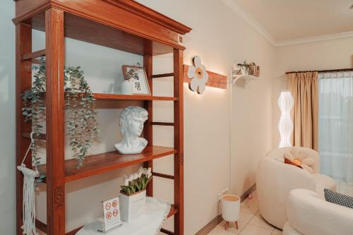 a living room with a book shelf and a chair at Gee homestay in Kota Kinabalu