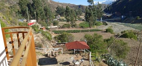 a view of a valley with a house and a river at Ecolodge Casa del Montañista in Huaraz