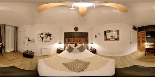 a bedroom with a large bed in a room at Chambres d'Hôtes La Filature in Saint-Quentin