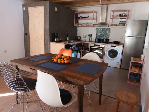 a kitchen with a table with a bowl of fruit on it at Danesi Studio - да ναι si Studio in Leonidion