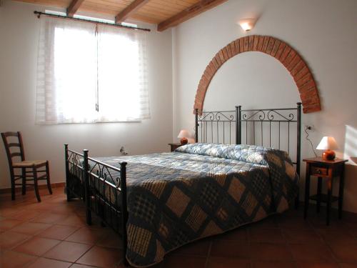 a bedroom with a bed and a large mirror at Appartamenti Il Granaio in Marina di Grosseto