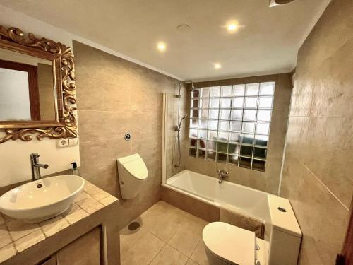 a bathroom with a sink and a toilet and a tub at Casita Neptuno in Palma de Mallorca