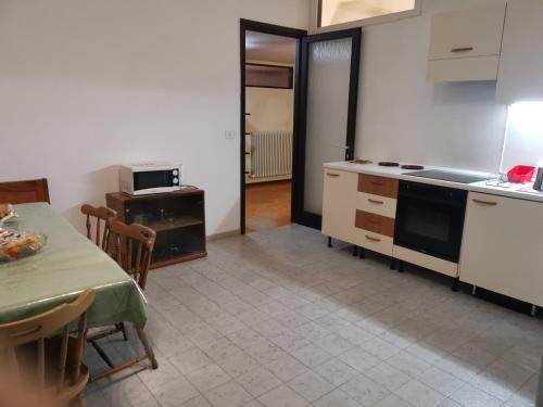 a kitchen with a table and a stove top oven at B&B VILLA DIEGO in Sondrio