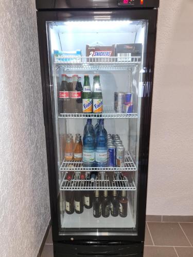 a refrigerator filled with lots of soda and sodas at AMW Ferienwohnungen in Legau