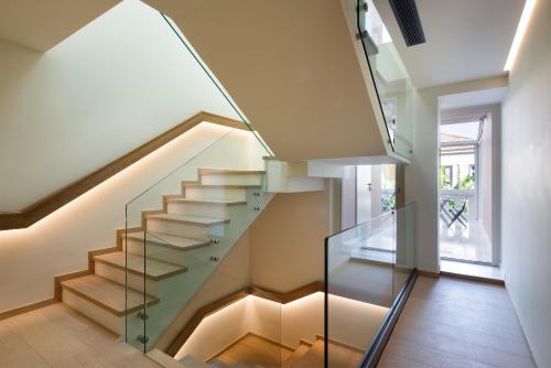 a glass staircase in a house at Epoch House & The Orange Shop - Adults Only in Nafplio