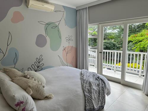 a bedroom with a teddy bear laying on a bed at Off Shore Ballito in Ballito