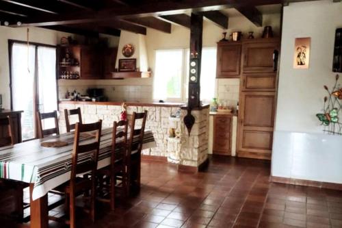 a kitchen with a table and chairs and a stove at Maison familiale Pays Basque in Ahaxe-Alciette-Bascassan