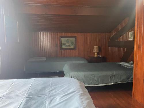 a bedroom with two beds and a staircase at Maison familiale Pays Basque in Ahaxe-Alciette-Bascassan