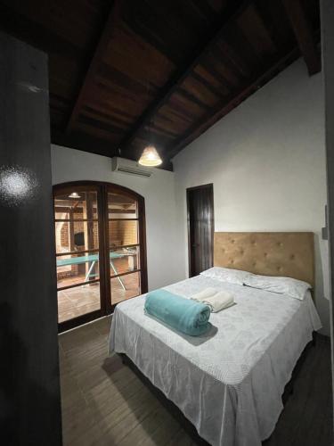Un dormitorio con una cama con una almohada azul. en Casa Marrom, en Bombinhas