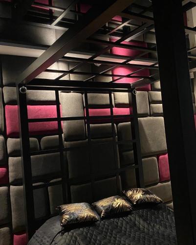 a bunk bed with two pillows on it in a room at Apartament ARKANA PREMIUM in Świętochłowice