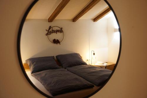 a mirror reflecting a bed in a bedroom at Apart Lisa in Huben