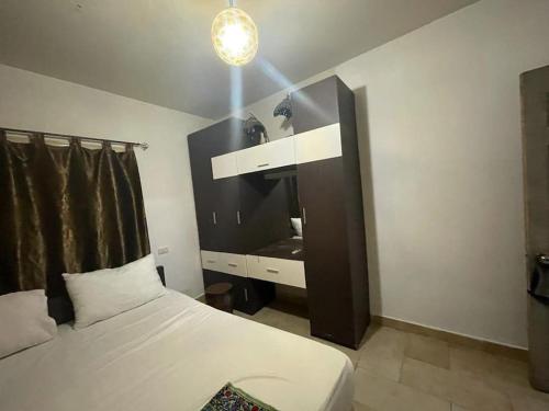a bedroom with a bed and a dresser in it at 2 bed 2 bath,pool facility,roof top with sea view in Sharm El Sheikh