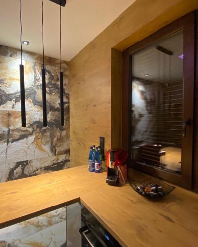 a kitchen with a counter with a large mirror at Apartament ARKANA PREMIUM in Świętochłowice