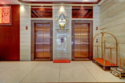 a hallway with doors and a staircase in a building at Hotel Gurudev Grand in Kalyan
