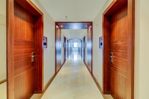 a hallway with wooden doors and a hallwayngth at Hotel Gurudev Grand in Kalyan