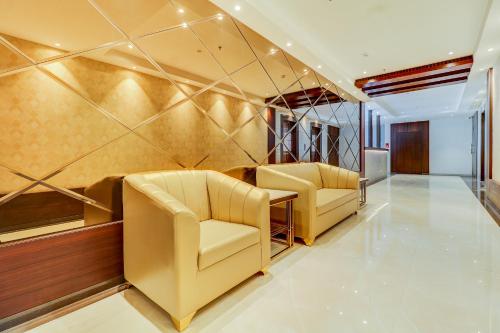 a waiting room with two chairs in a building at Hotel Gurudev Grand in Kalyan