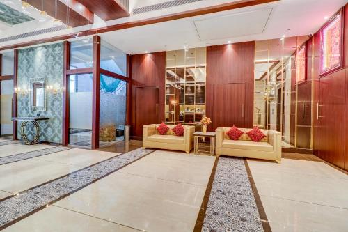 a lobby with two couches and a table at Hotel Gurudev Grand in Kalyan