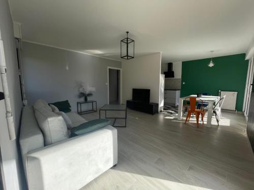 a living room with a white couch and a table at La montagne ça vous gagne ! in Cluses