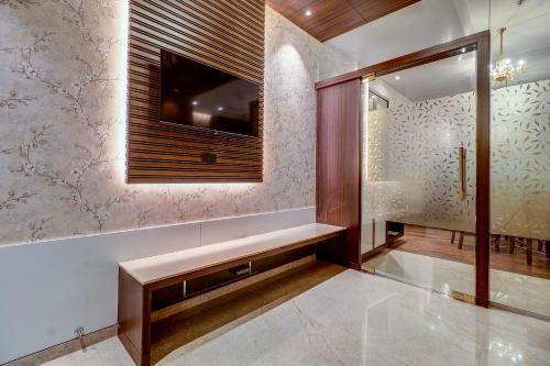 a hallway with a bench and a window at Hotel Gurudev Grand in Kalyan
