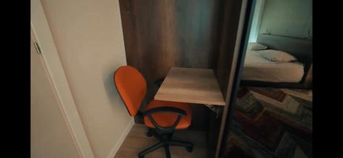 a room with a desk and a chair and a mirror at Green Coast Resort V94 in Palasë