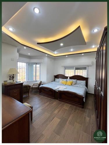 a bedroom with a large bed with a coffered ceiling at AlSalti Farm - مزرعة السلطي in Ajloun