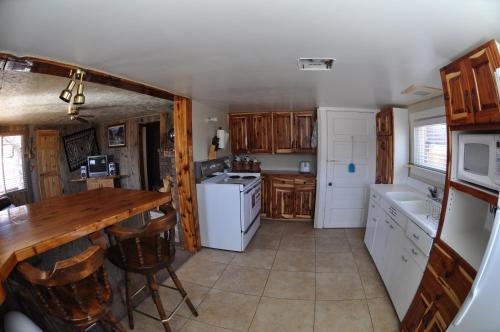 a kitchen with wooden cabinets and a wooden counter top at Wild West Retreat in Escalante
