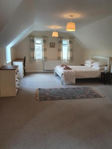 a large bedroom with two beds and a rug at Villa Muneera - rural retreat in the heart of Pembrokeshire in Narberth