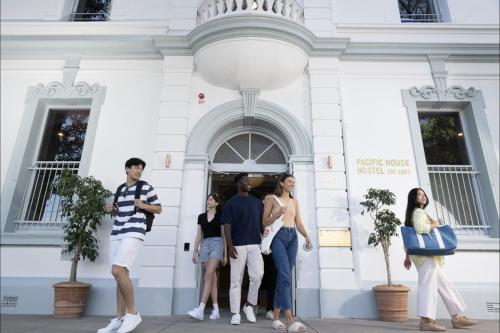 a group of people standing outside of a building at The Pacific House in Sydney