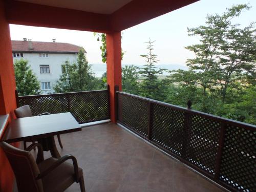 a balcony with a table and chairs and a view at Sapanca Dilek Konagi Hotel in Sapanca